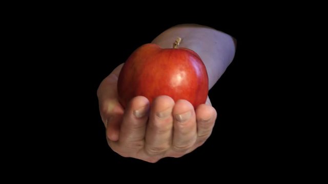 Original sin interpretation with apple in hand on black background