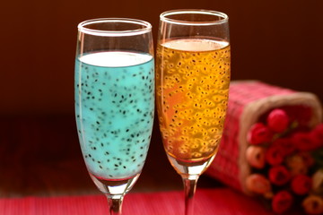 Glass healthy drink mix basil seeds brown backdrop.