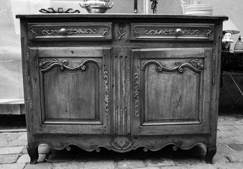 Vintage luxury dresser at flea market in Paris (France). Black and white.