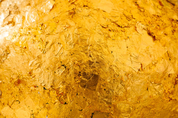 Gild texture on gold buddha statue background, Which Buddhist people use to worship The sacred