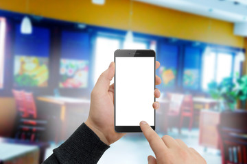 Man in restaurant holding modern black phone in hand. Shopping online concept mockup. Blurred restaurant in background