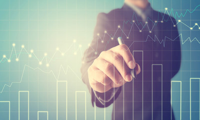 Double exposure of business man writing with financial graph.Business Trading concept.investment...