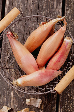Shallot onions on old rustic wooden board