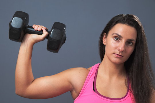 Sporty Woman Lifting Dumbbell