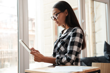 Amazing young caucasian woman using tablet computer