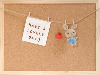 Cork message board with a paper note and a handmade knitted crochet rabbit doll. Ideas for leaving a cute message for special occasion like birthday, anniversary and Valentines day.