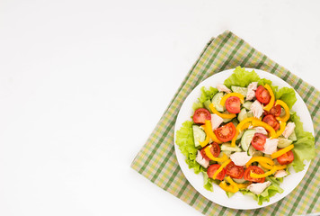 Salad with chicken and fresh vegetables on white background. Flat lay.