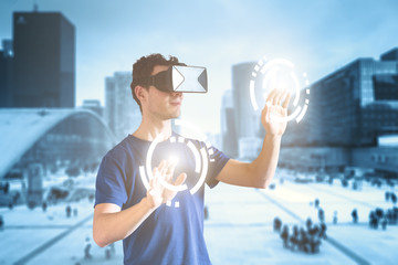 Double exposure person wearing virtual reality (VR) headset and cityscape