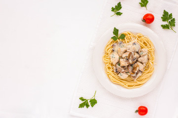 Spaghetti pasta with champignons, chiken and sauce on white background. Flat lay.