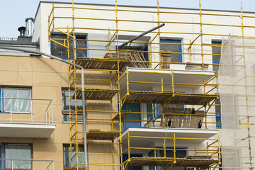 Construction scaffolding of a modern apartment building under construction. Poland.