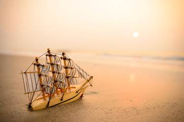 Sailing ship model on the beach, discovery concept.