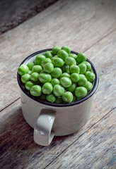 green peas on a wooden background