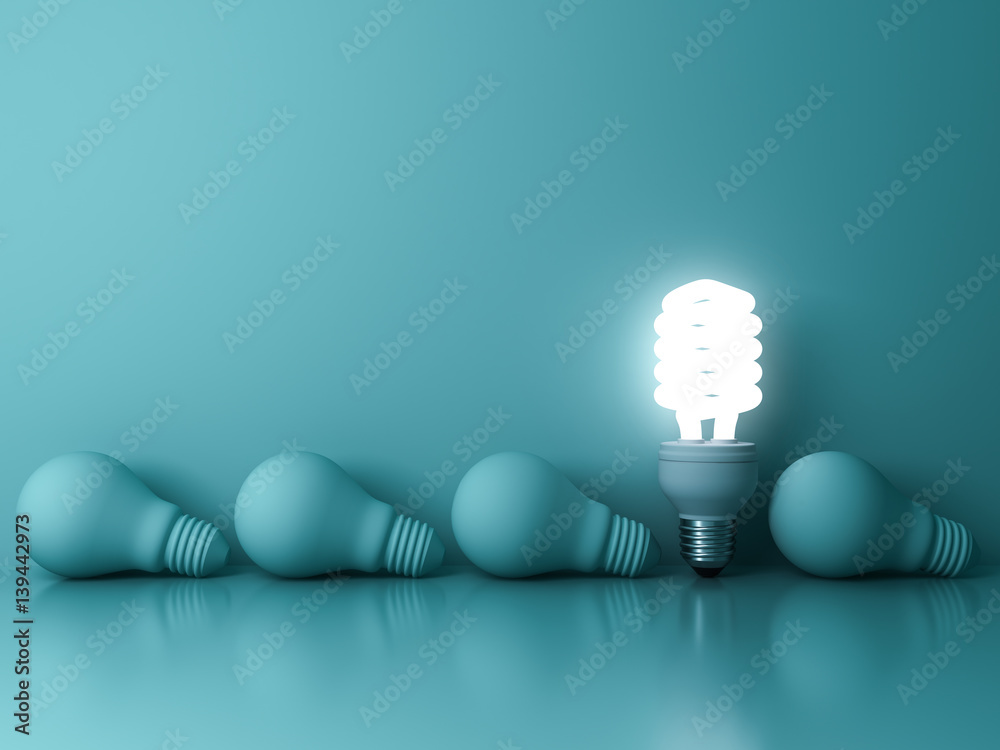 Aufkleber energy saving light bulb , one glowing fluorescent lightbulb standing out from dead incandescent bul