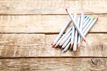 Drawing colourful pencils on brown wooden table