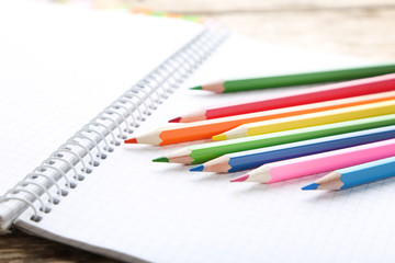 Drawing colourful pencils with blank notebook