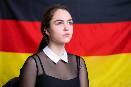 Beautiful calm brunette girl in the background of the German flag