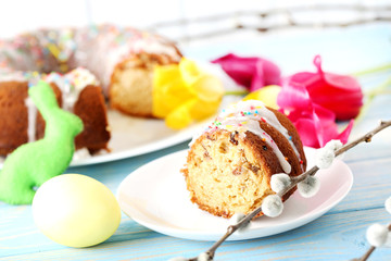Easter eggs with cake on a blue wooden table