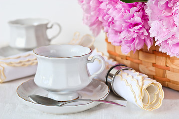 Cup, napkin and peonies