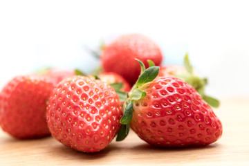 Red Strawberry on Wooden Plate