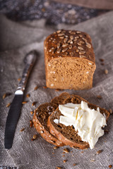 Fresh bread and homemade butter on wooden background