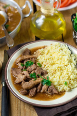 Pork fricassee stew in tomato sauce with semolina