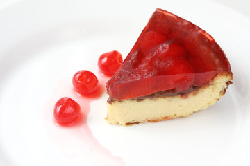 isolated on white served slice of delicious cherry cheese cake with cherry topping