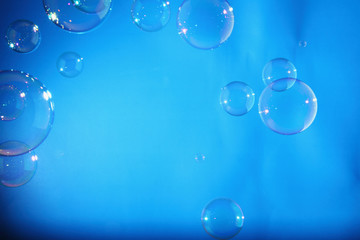 Rainbow soap bubbles on a blue backgrounds