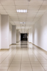 Empty long corridor in the modern office building. background