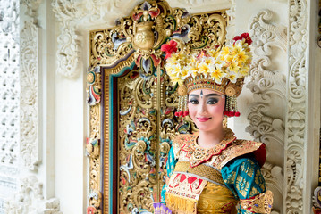 balinese legong dancer at decorative door
