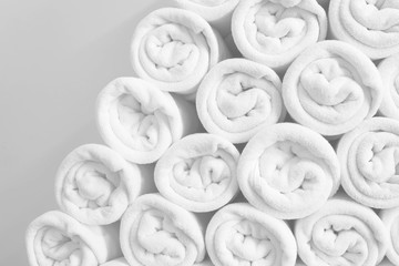 Rolled up white spa towels or bath towels keep in store room .