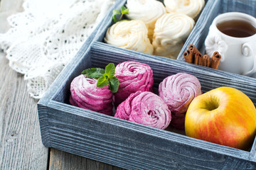 Homemade marshmallows on a light background. Russian currant and mango zephyr. Selective focus.