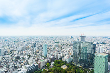 Business and culture concept - panoramic modern city skyline bird eye aerial view under dramatic sun and morning blue cloudy sky in Tokyo, Japan