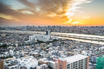 Fototapeta premium Business and culture concept - panoramic modern city skyline bird eye aerial view with Mountain Fuji under dramatic sunset glow and beautiful cloudy sky in Tokyo, Japan