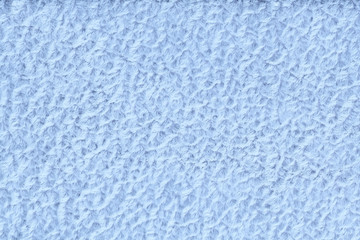 Fototapeta na wymiar Light blue fluffy background of soft, fleecy cloth. Texture of textile closeup