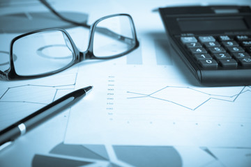 Business and finance concept.Calculator,chart,document,pen and graph on the table.