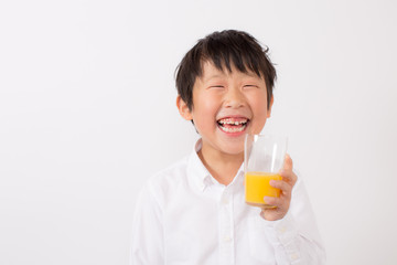 オレンジジュースを飲む子供