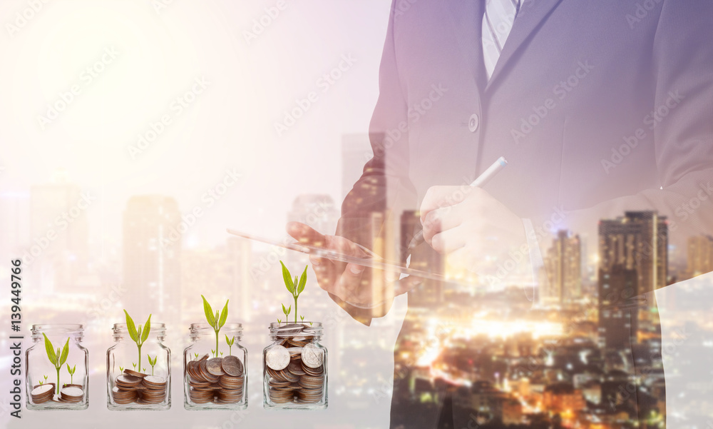 Poster double exposure of business man working with a digital tablet with cityscape blurred building backgr