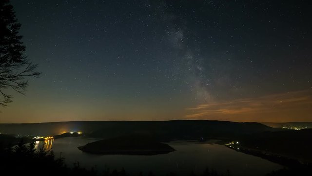 Timelapse sequence of the milky way above lake Rursee in Germany through the short summer night