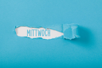 Mittwoch, German Wednesday weekday message on Paper torn ripped opening