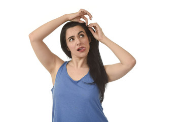 casual portrait of young attractive latin woman fixing her hair with hairpin