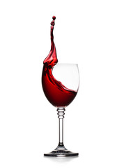 glass of splashing red wine isolated on white