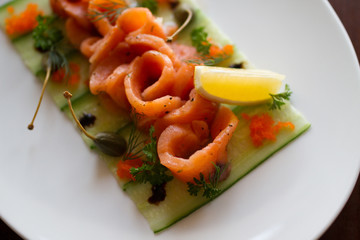 Salted salmon with lemon on brown background