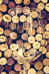 Detail of wine glass and corks in filtered old vintage style