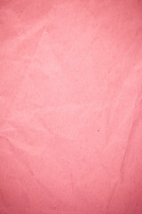 Crumpled recycle pink paper background.