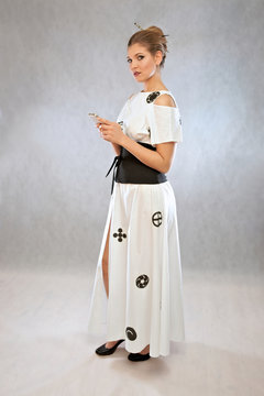 Woman with mobile phone, in a dress inspired by the Japanese kimono