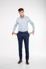 Vertical image of Man showing empty pockets