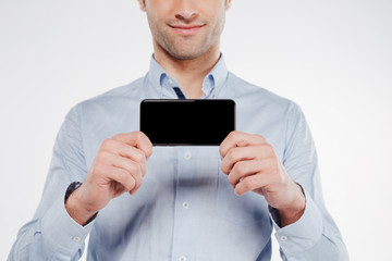 Cropped image of man showing blank smartphone screen