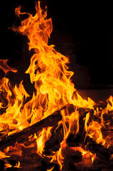 Obraz premium Yellow and hot blaze of fire in the dark