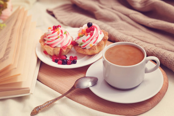 Cake with cream and berries for breakfast in bed