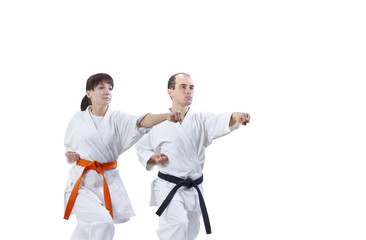 With black belt and orange belt the athletes are beating punch arm